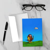 Greeting card featuring a cartoon creature wearing a raincoat, life jacket, and rain boots while carrying two umbrellas and staring nervously at a single cloud overhead.
