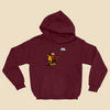 Hoodie featuring a cartoon creature wearing a raincoat, life jacket, and rain boots while carrying two umbrellas and staring nervously at a single cloud overhead.