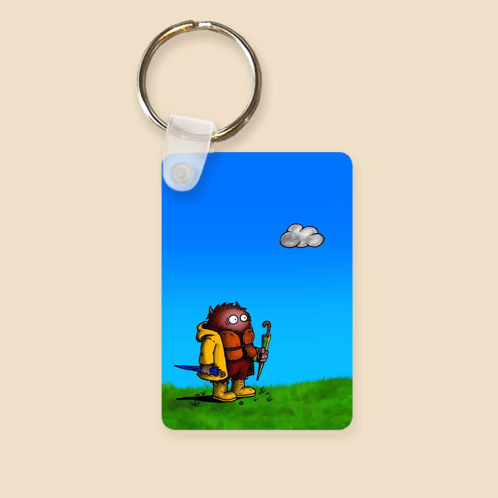 Keychain featuring a cartoon creature wearing a raincoat, life jacket, and rain boots while carrying two umbrellas and staring nervously at a single cloud overhead.