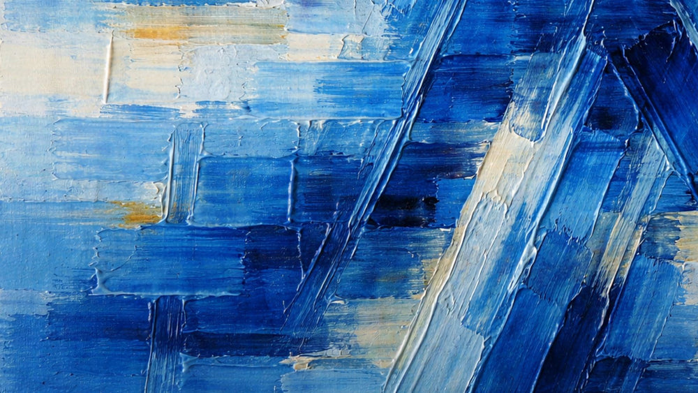 Abstract oil painting in layered shades of blue, featuring structured, deliberate brushstrokes that intersect in clean, organized angles. Thick, textured paint creates depth with lighter blue and neutral accents adding contrast and balance.