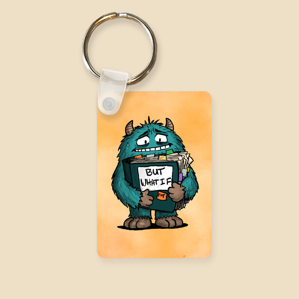 But What If OCD keychain featuring an anxious blue monster clutching an overflowing binder labeled “But What If?”