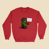 Red sweatshirt featuring a cartoon creature in a green hoodie holding a sign reading “I do not wish to be perceived.”