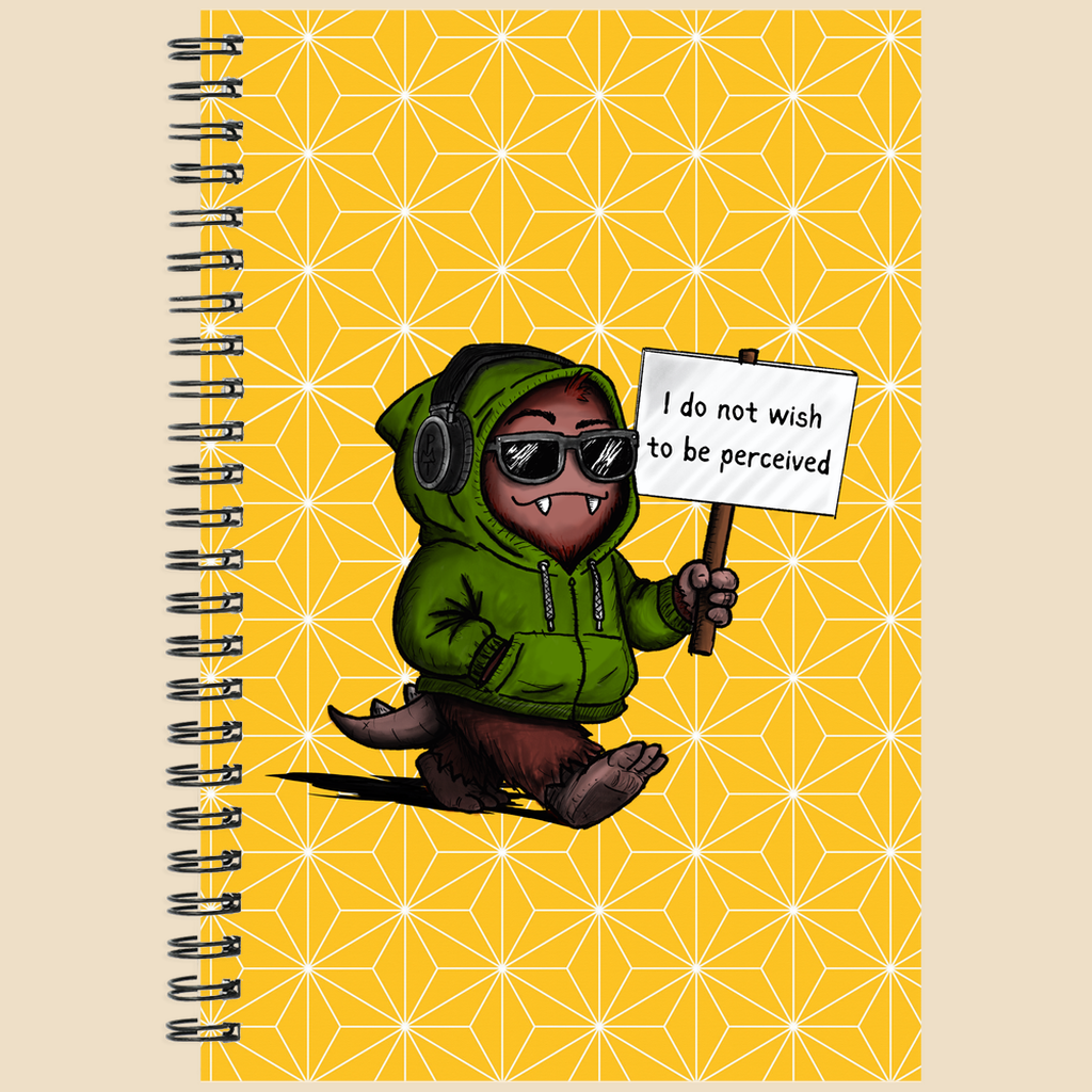 Spiral notebook featuring a cartoon creature in sunglasses and a green hoodie holding a sign reading “I do not wish to be perceived” on a yellow background with geometric star details.