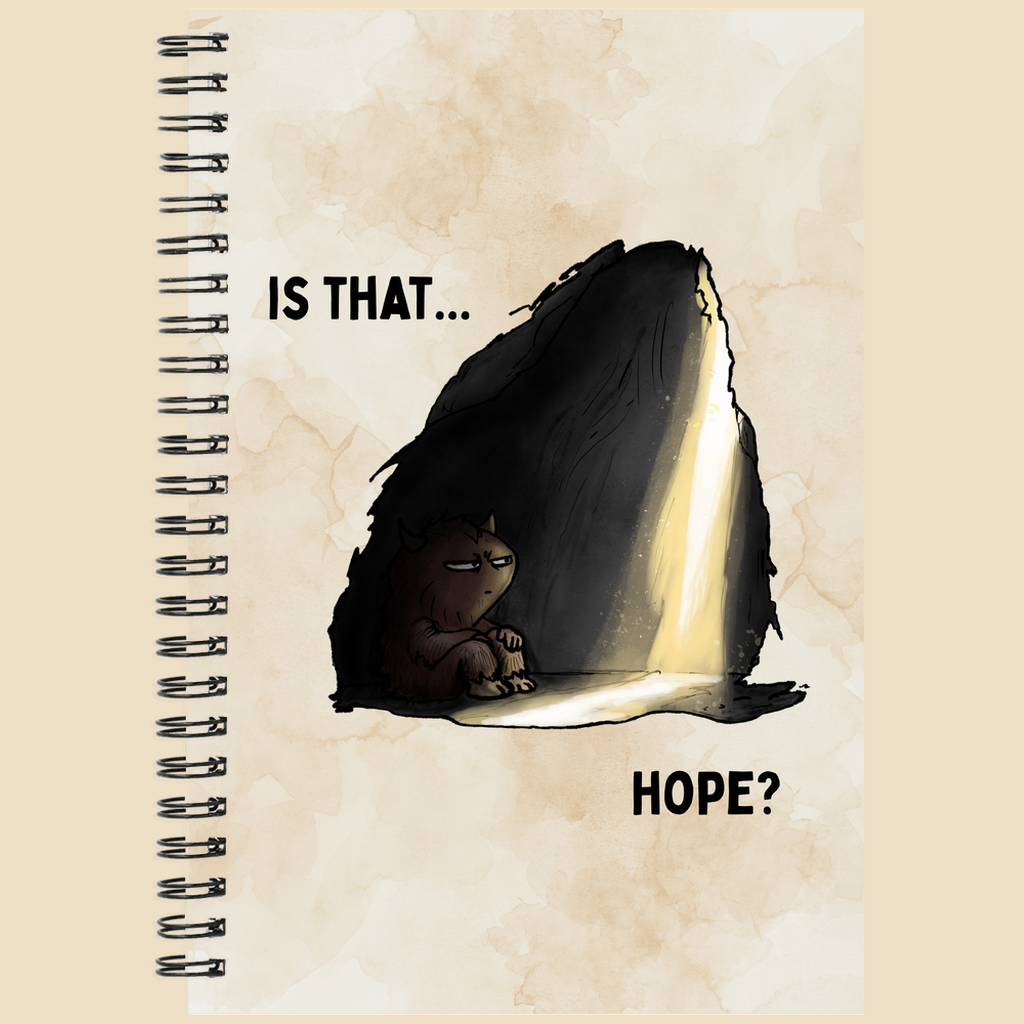 Is That Hope mental health humor notebook featuring a tired brown monster sitting in a dark cave as a beam of warm light breaks through, with the words “Is That... Hope?”