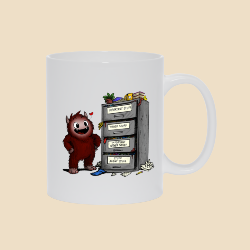 Mug featuring a smiling cartoon creature proudly standing beside an overflowing filing cabinet with drawers labeled "Important Stuff," "Other Stuff," "Important Other Stuff," and "Stuff About Stuff."