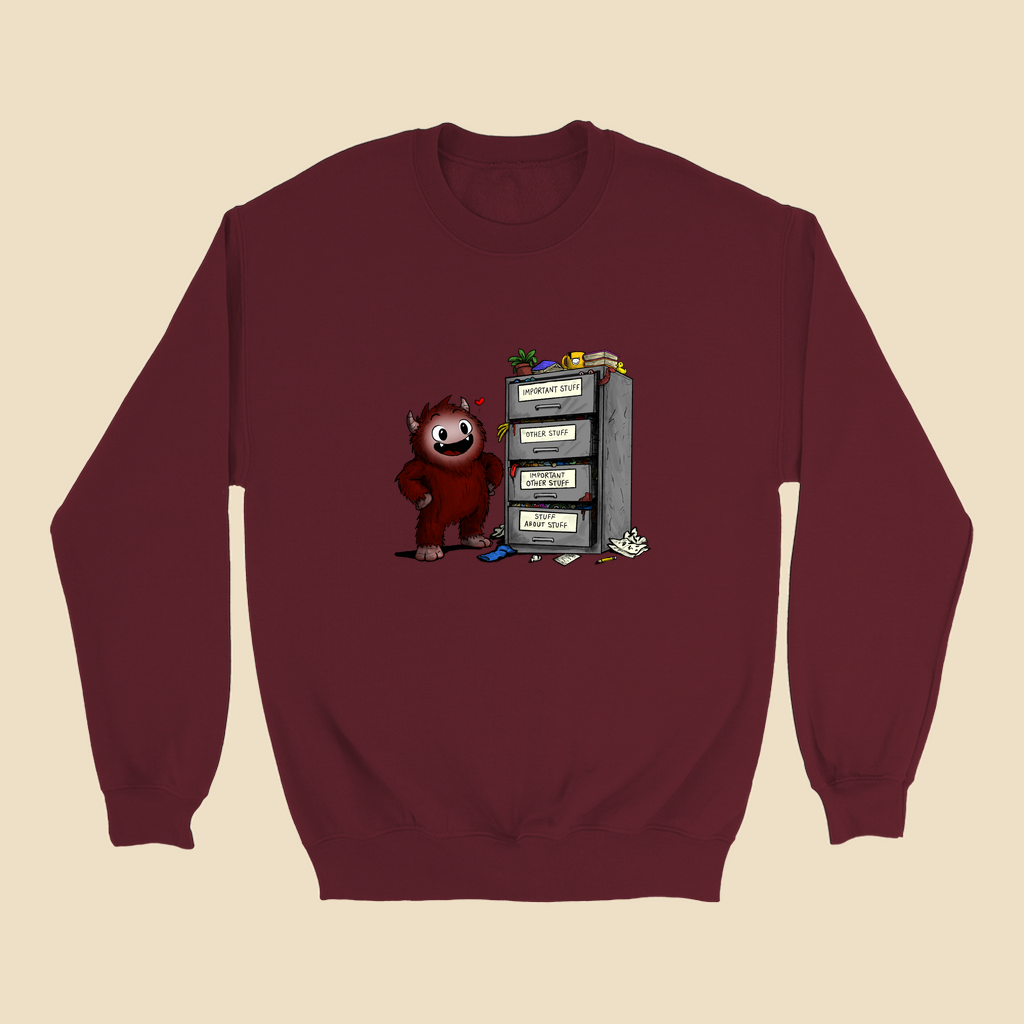 Sweatshirt featuring a smiling cartoon creature proudly standing beside an overflowing filing cabinet with drawers labeled "Important Stuff," "Other Stuff," "Important Other Stuff," and "Stuff About Stuff."
