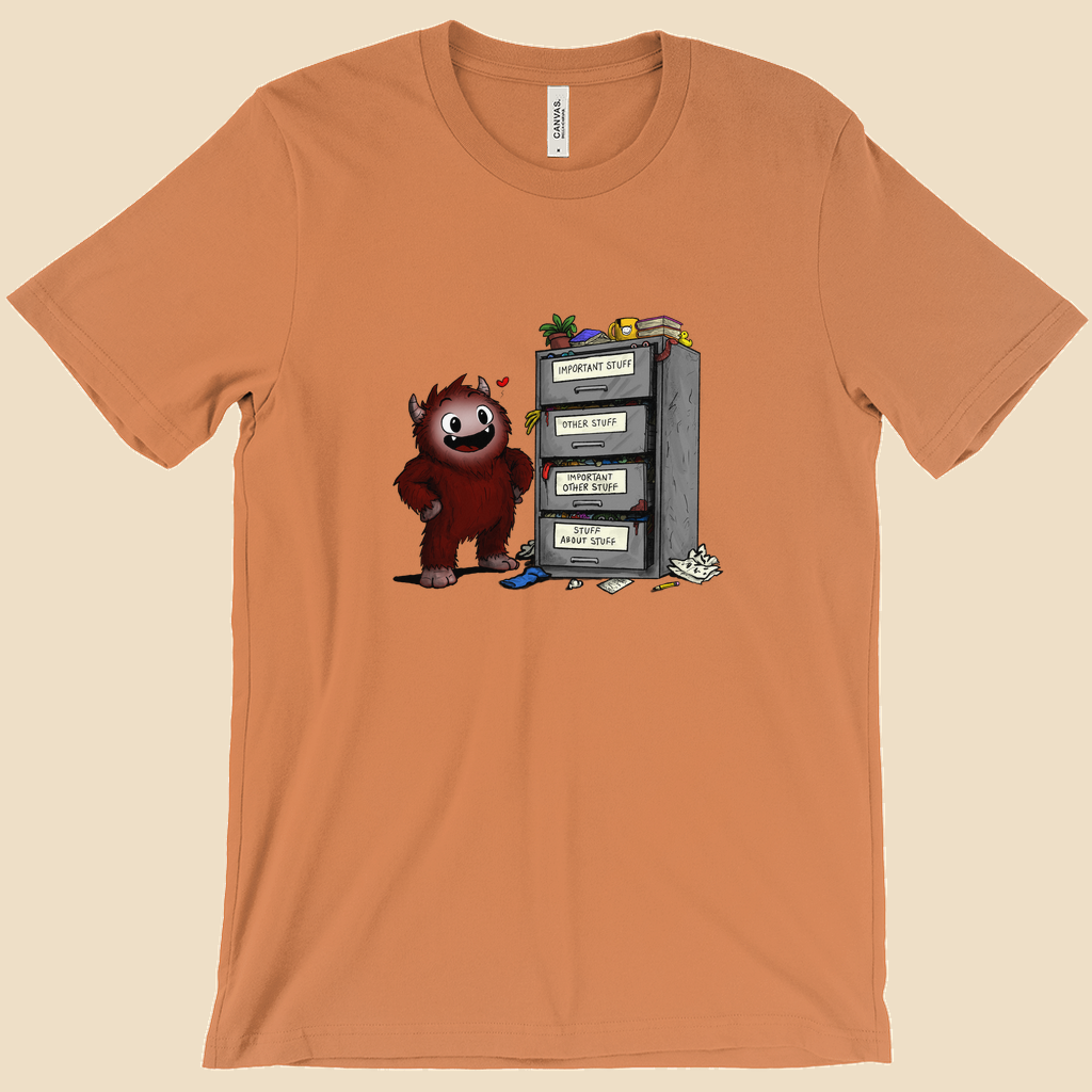 T-shirt featuring a smiling cartoon creature proudly standing beside an overflowing filing cabinet with drawers labeled "Important Stuff," "Other Stuff," "Important Other Stuff," and "Stuff About Stuff."