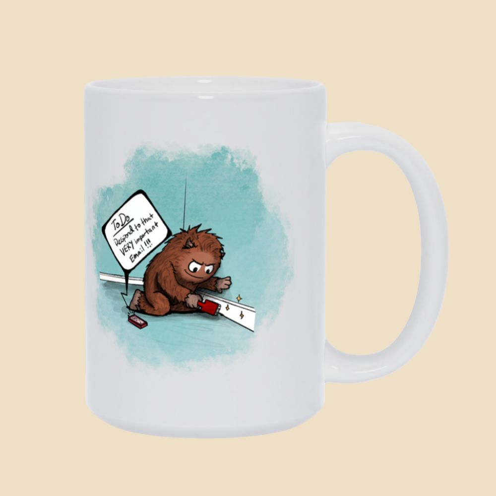 White mug featuring a brown furry monster sitting on the floor cleaning a baseboard while a phone reminds him to respond to an important email.