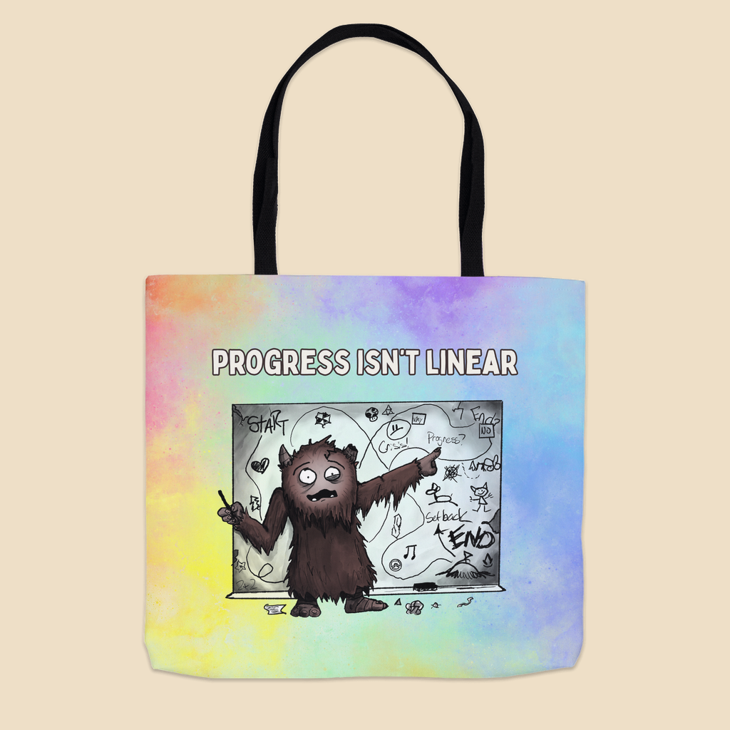 Progress Isn’t Linear tote bag featuring a furry brown monster pointing at a messy, winding progress chart filled with twists, turns, setbacks, and doodles.