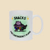 White mug featuring the “Snacks and Contingency Plans” anxiety humor design with a purple monster dressed like a superhero and carrying pouches of backup supplies.