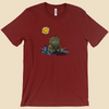 T-shirt featuring a furry monster sitting miserably in the sunshine while the cheerful world around it enjoys a beautiful day.