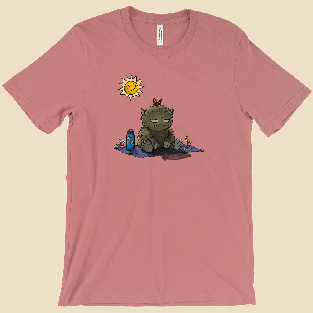 T-shirt featuring a furry monster sitting miserably in the sunshine while the cheerful world around it enjoys a beautiful day.