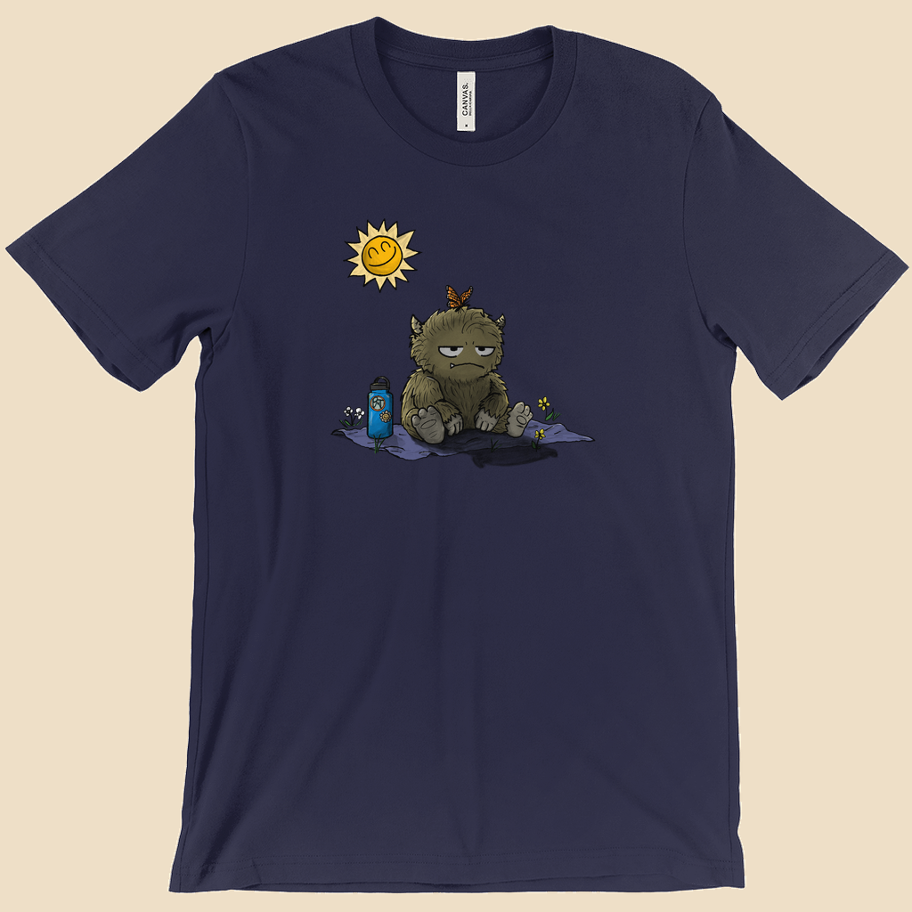 T-shirt featuring a furry monster sitting miserably in the sunshine while the cheerful world around it enjoys a beautiful day.