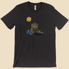 T-shirt featuring a furry monster sitting miserably in the sunshine while the cheerful world around it enjoys a beautiful day.