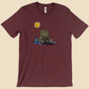 T-shirt featuring a furry monster sitting miserably in the sunshine while the cheerful world around it enjoys a beautiful day.