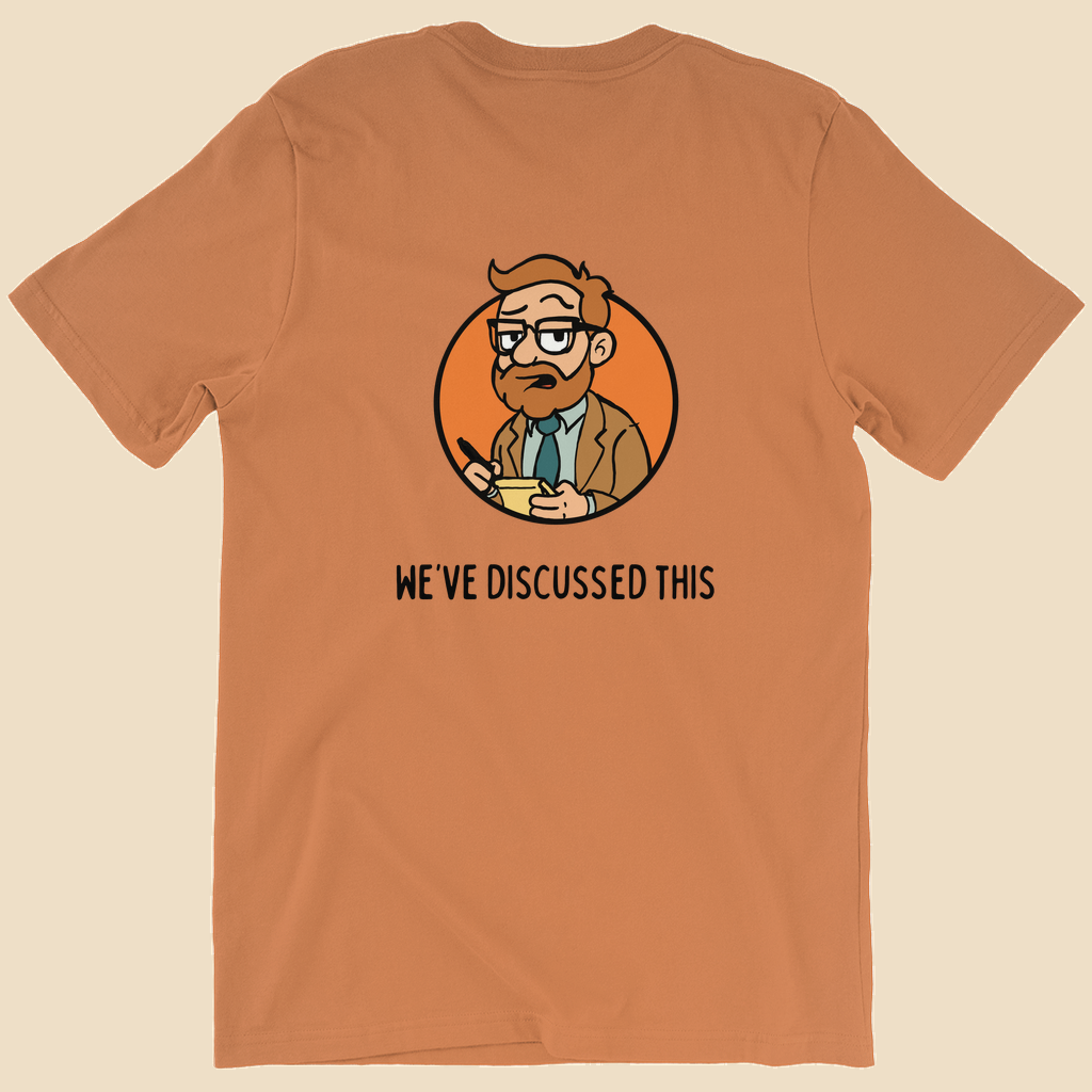 Per My Therapist T-shirt with small black Per My Therapist logo on the front chest and a large Arnold therapist illustration on the back with the words “We’ve Discussed This.”