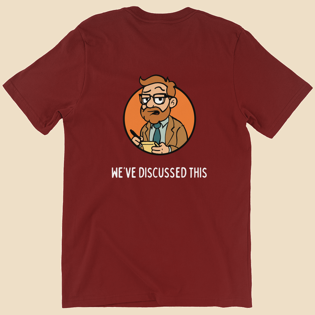 Per My Therapist T-shirt with small white Per My Therapist logo on the front chest and a large Arnold therapist illustration on the back with the words “We’ve Discussed This.”