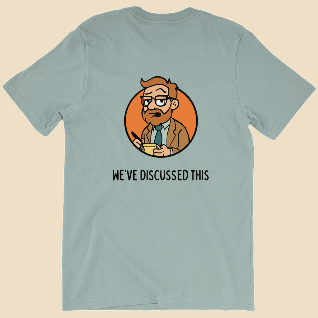 Per My Therapist T-shirt with small black Per My Therapist logo on the front chest and a large Arnold therapist illustration on the back with the words “We’ve Discussed This.”