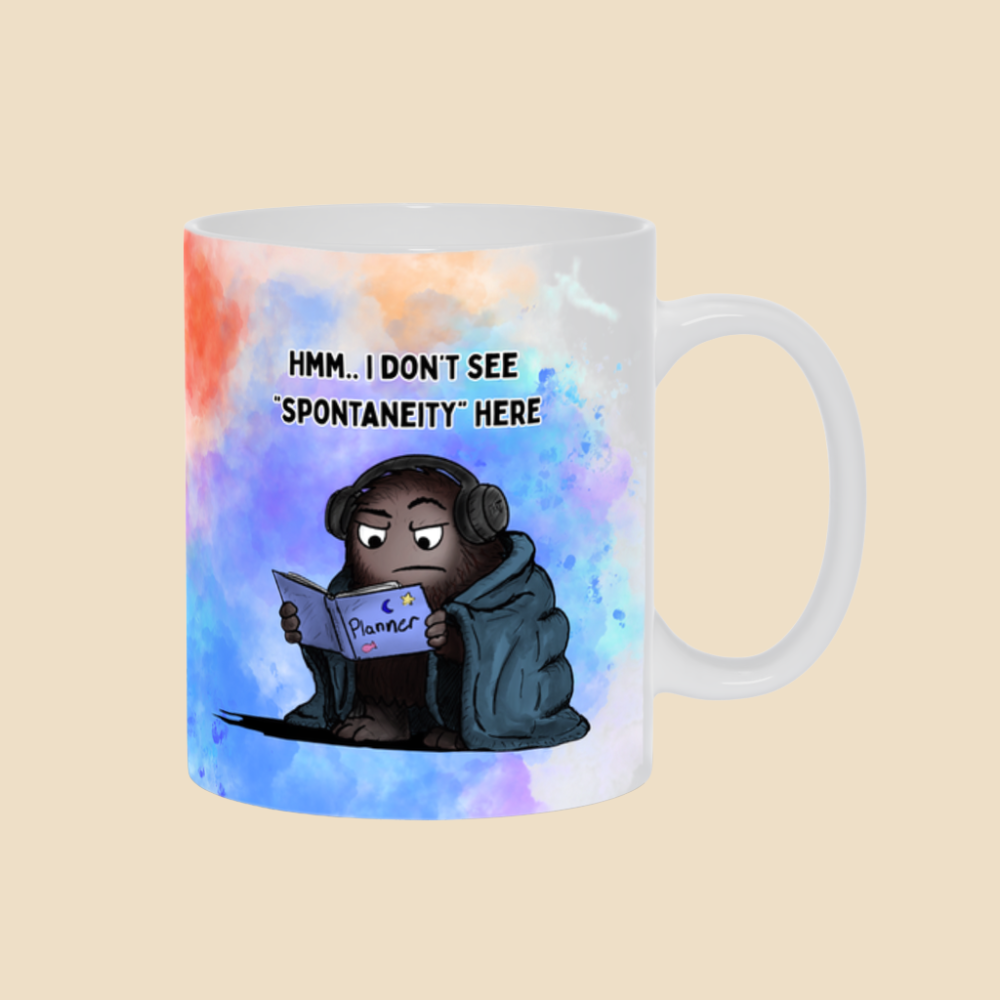 What Is Spontaneity funny mental health mug featuring two monsters joking about scheduling spontaneity.
