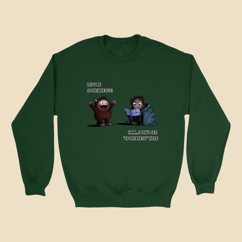 Sweatshirt featuring two cartoon creatures, one saying “Let’s be spontaneous!” while the other checks a planner and replies, “Hmm... I don’t see ‘spontaneity’ here.”
