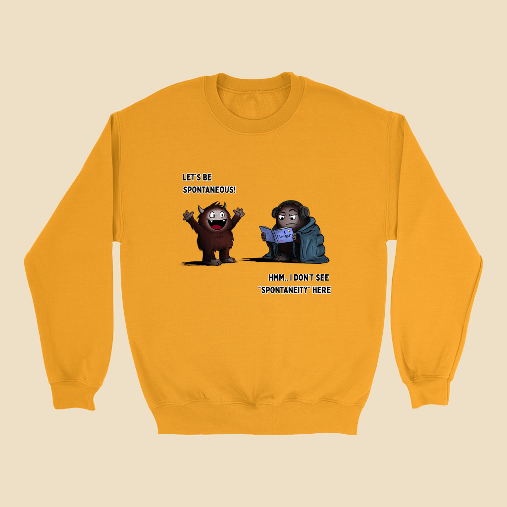 Sweatshirt featuring two cartoon creatures, one saying “Let’s be spontaneous!” while the other checks a planner and replies, “Hmm... I don’t see ‘spontaneity’ here.”