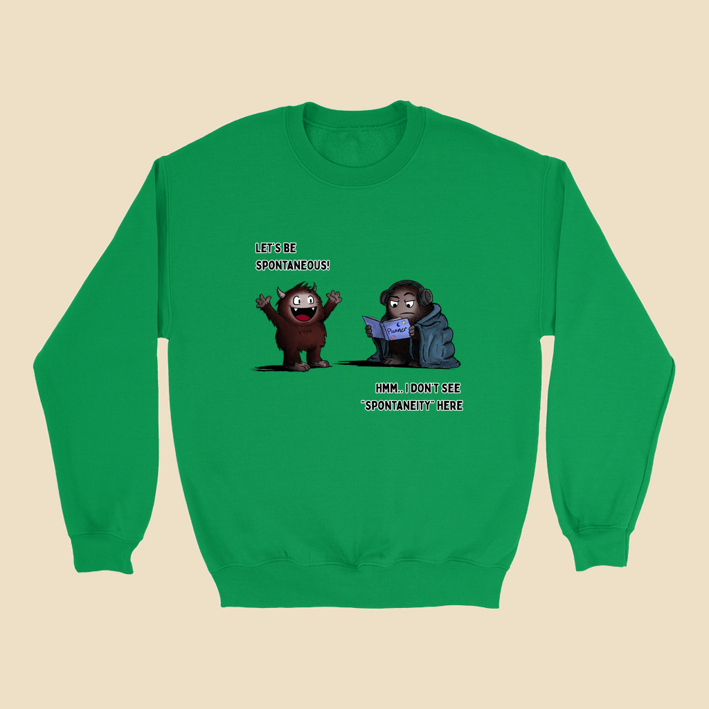 Sweatshirt featuring two cartoon creatures, one saying “Let’s be spontaneous!” while the other checks a planner and replies, “Hmm... I don’t see ‘spontaneity’ here.”