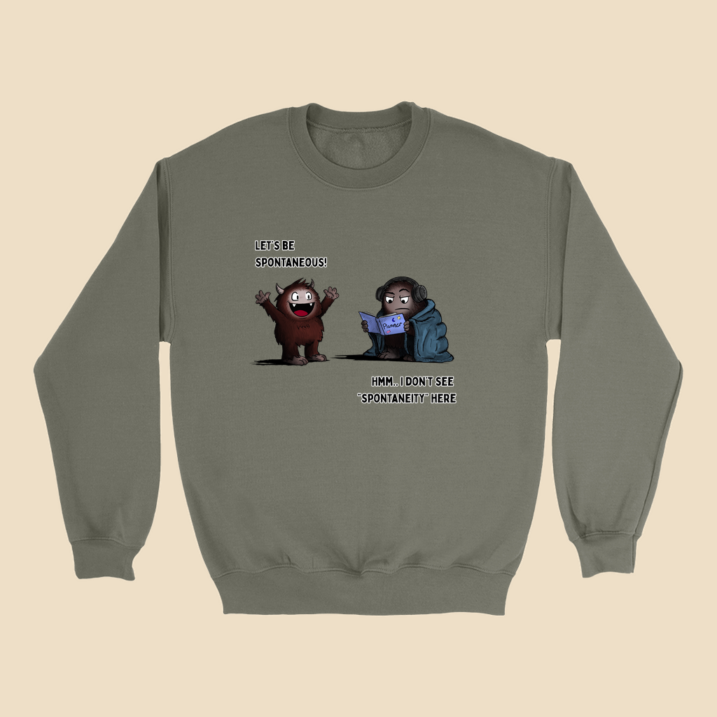 Sweatshirt featuring two cartoon creatures, one saying “Let’s be spontaneous!” while the other checks a planner and replies, “Hmm... I don’t see ‘spontaneity’ here.”