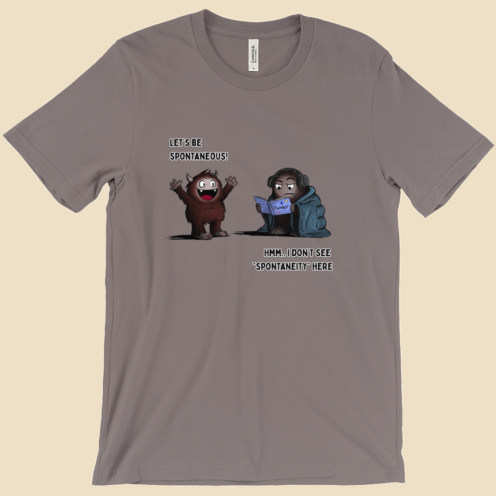 T-shirt featuring two cartoon creatures, one saying “Let’s be spontaneous!” while the other checks a planner and replies, “Hmm... I don’t see ‘spontaneity’ here.”