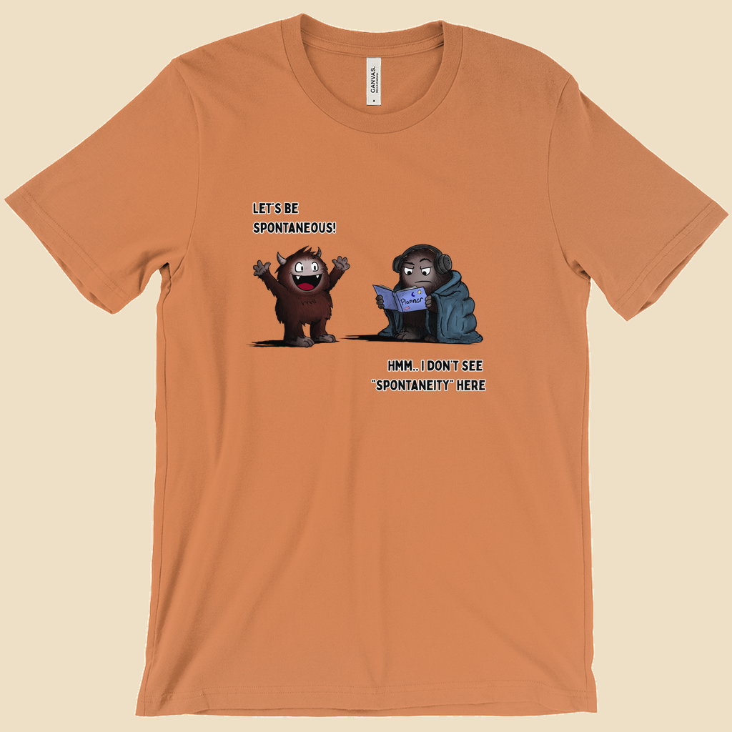 T-shirt featuring two cartoon creatures, one saying “Let’s be spontaneous!” while the other checks a planner and replies, “Hmm... I don’t see ‘spontaneity’ here.”