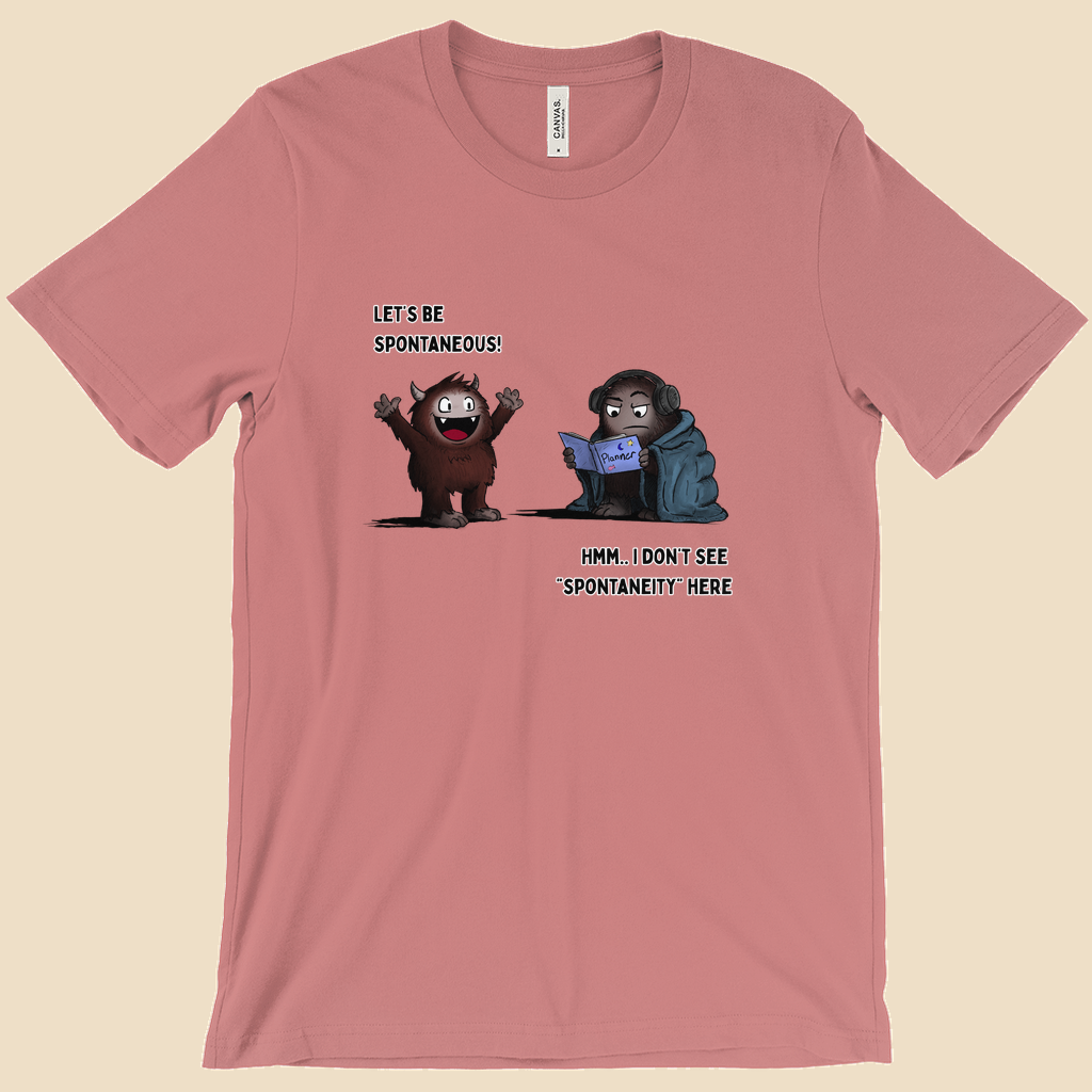 T-shirt featuring two cartoon creatures, one saying “Let’s be spontaneous!” while the other checks a planner and replies, “Hmm... I don’t see ‘spontaneity’ here.”