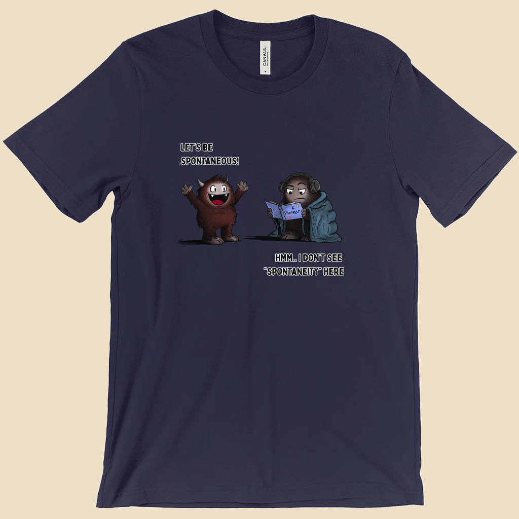T-shirt featuring two cartoon creatures, one saying “Let’s be spontaneous!” while the other checks a planner and replies, “Hmm... I don’t see ‘spontaneity’ here.”