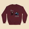 Sweatshirt featuring two cartoon creatures, one saying “Let’s be spontaneous!” while the other checks a planner and replies, “Hmm... I don’t see ‘spontaneity’ here.”